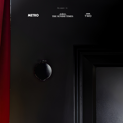 Black Mini Magflap magnetic keyhole cover installed on traditional timber door.